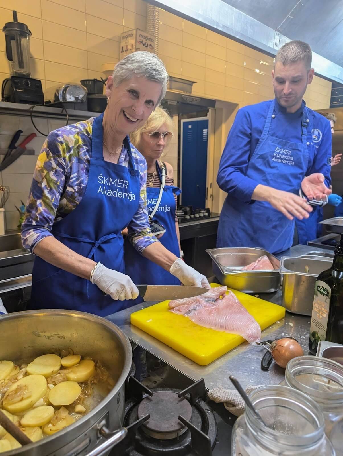 A diverse group of individuals collaborates in a kitchen, skillfully preparing various dishes together.