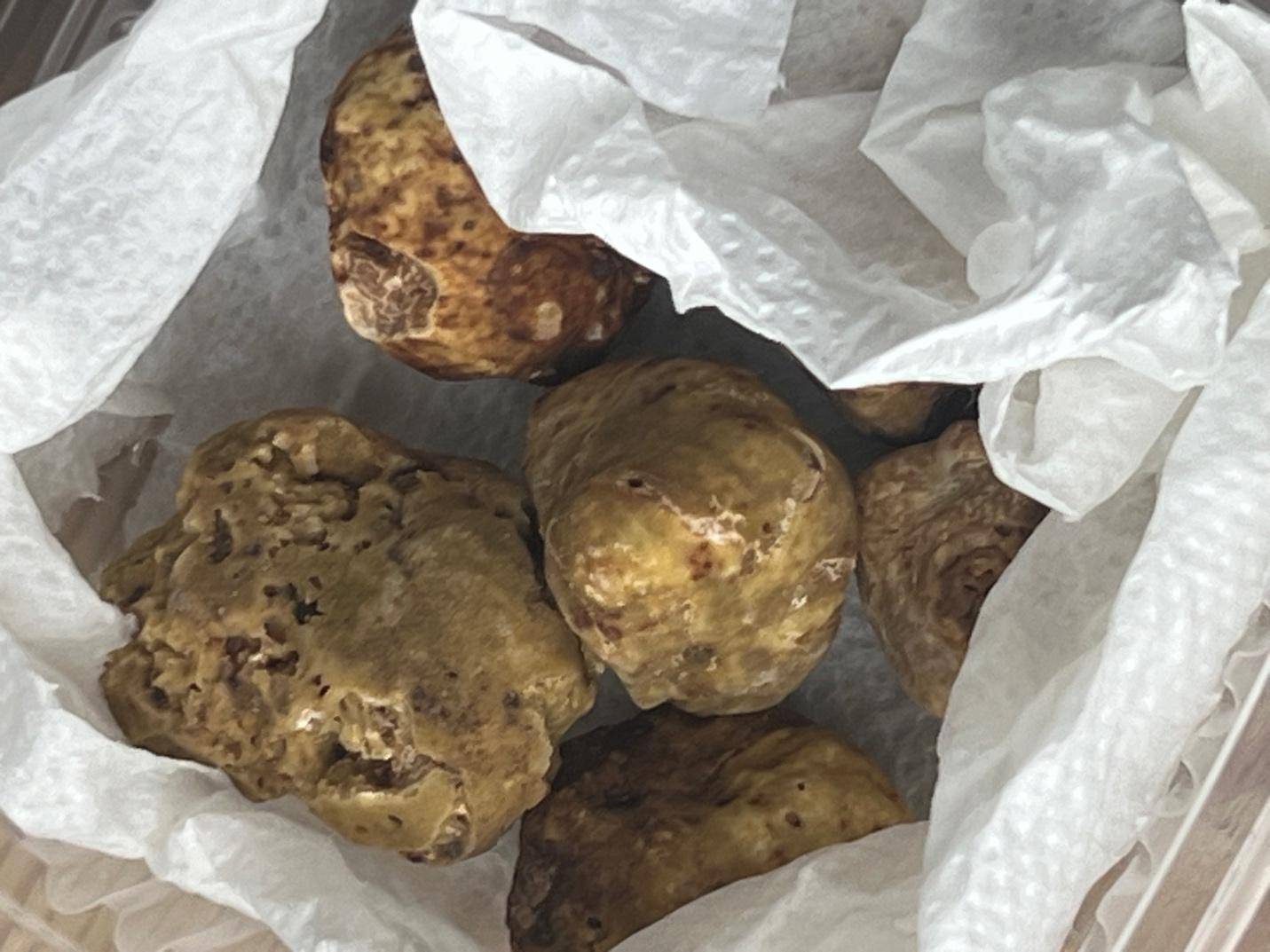 A paper bag containing raw meat