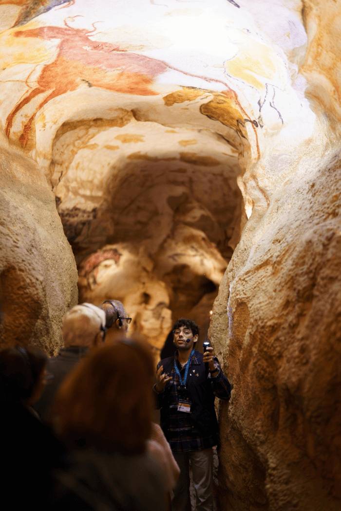 A group of people standing together inside a cave