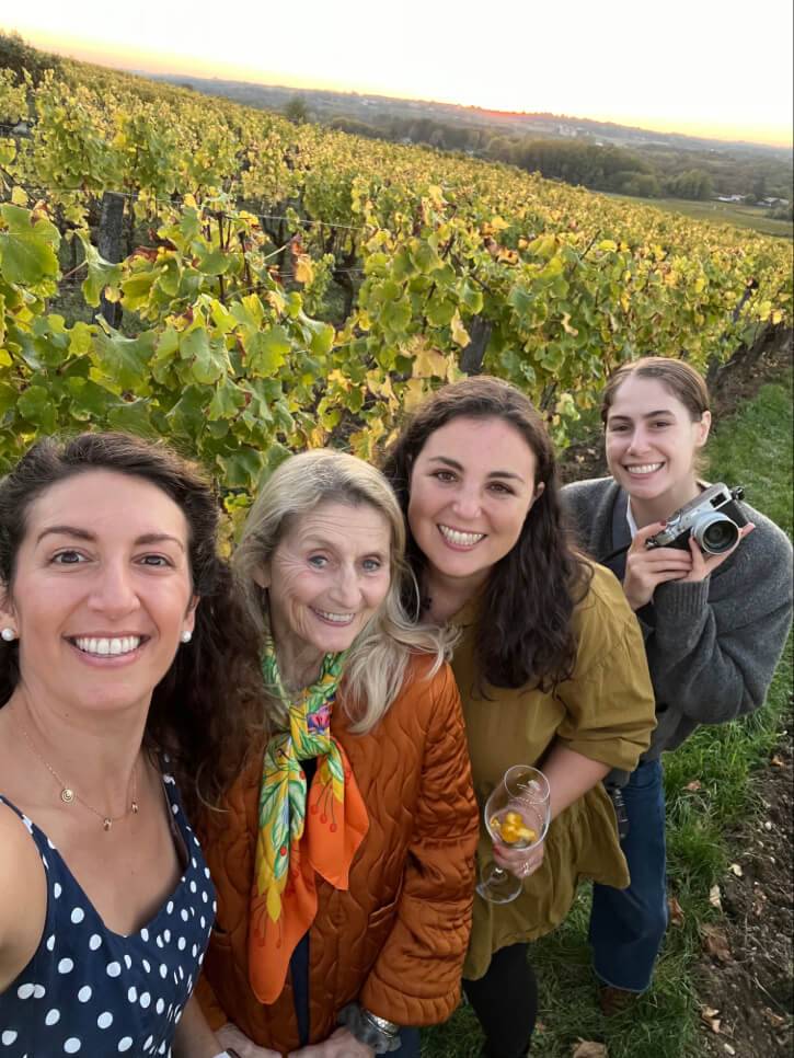 Three women smiling and taking a selfie