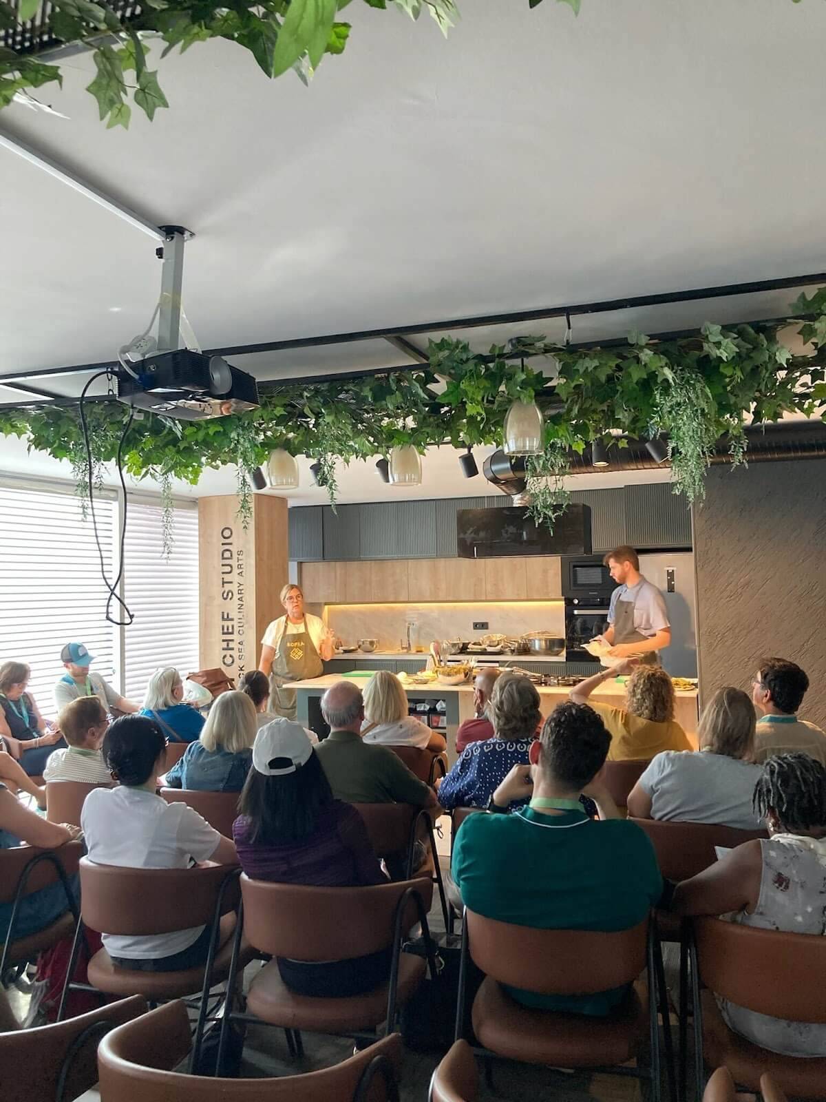 A diverse group of people in chairs, gathered together in a room for a meeting or discussion.