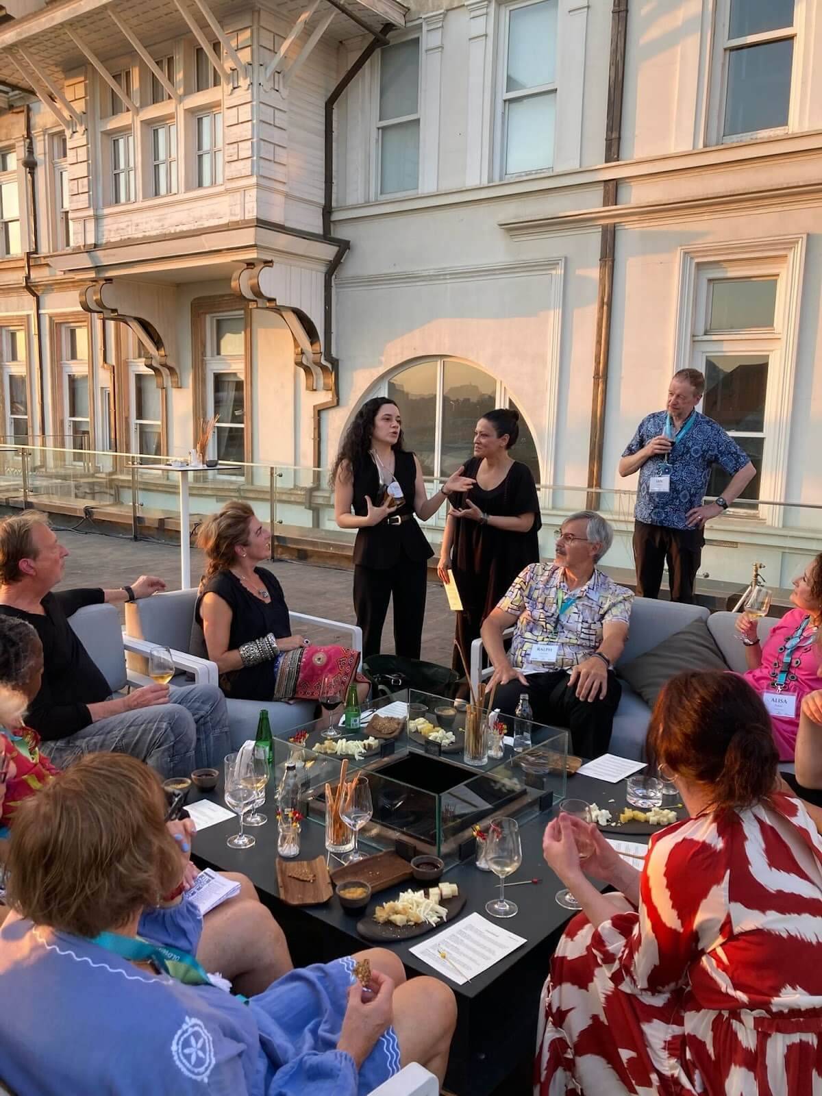 A group of people gathered around a table on a patio