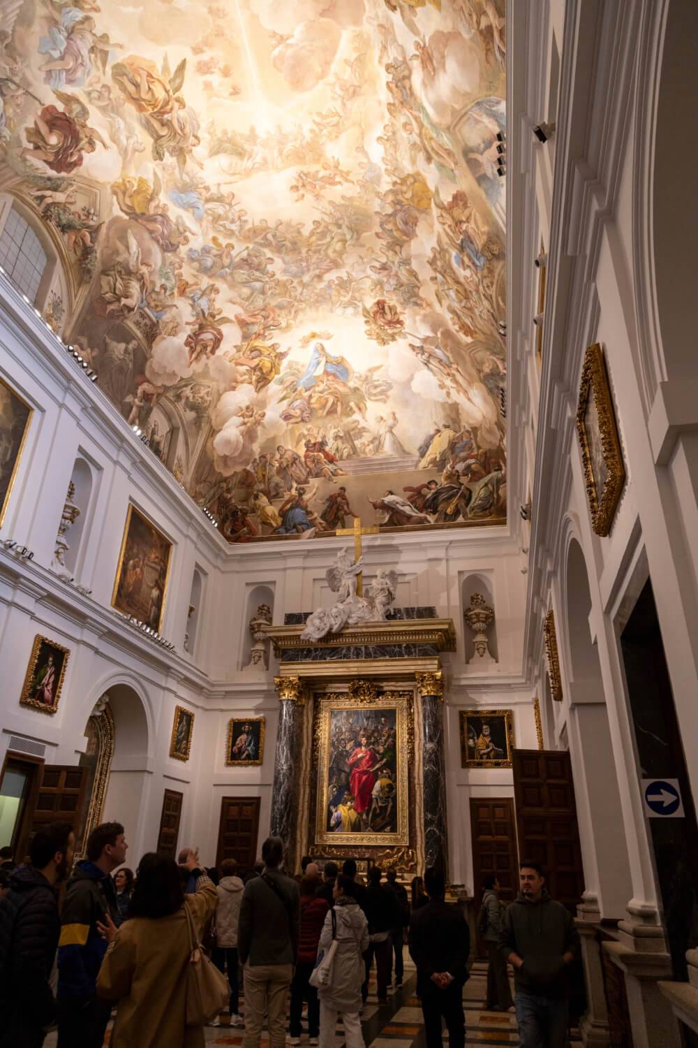 A large, ornate painting adorns the ceiling
