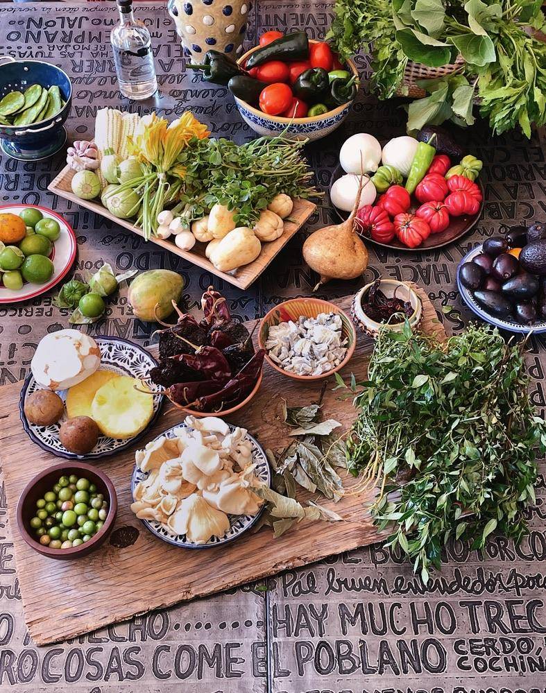 A table displaying a variety of colorful fruits and vegetables, showcasing their diverse shapes and sizes.