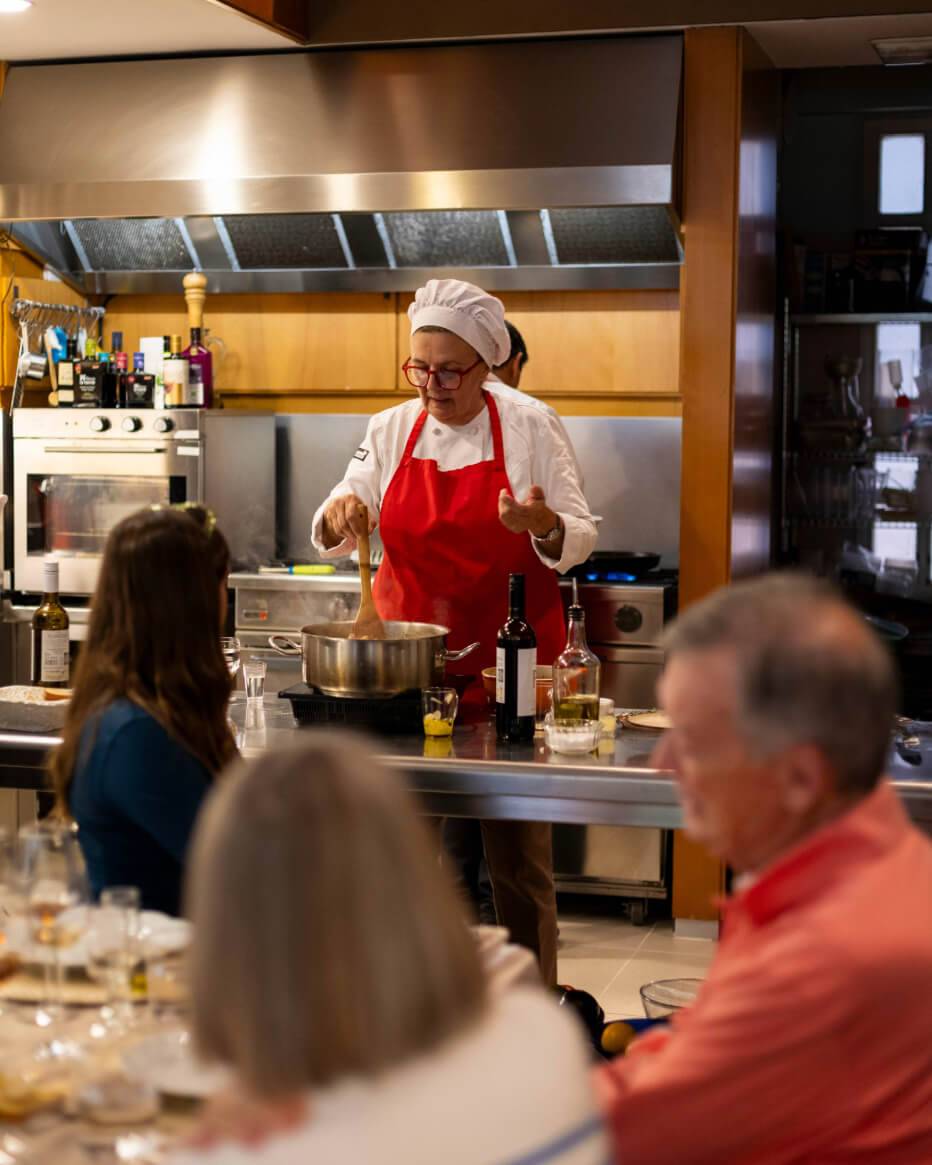 A woman in an apron is engaged in cooking