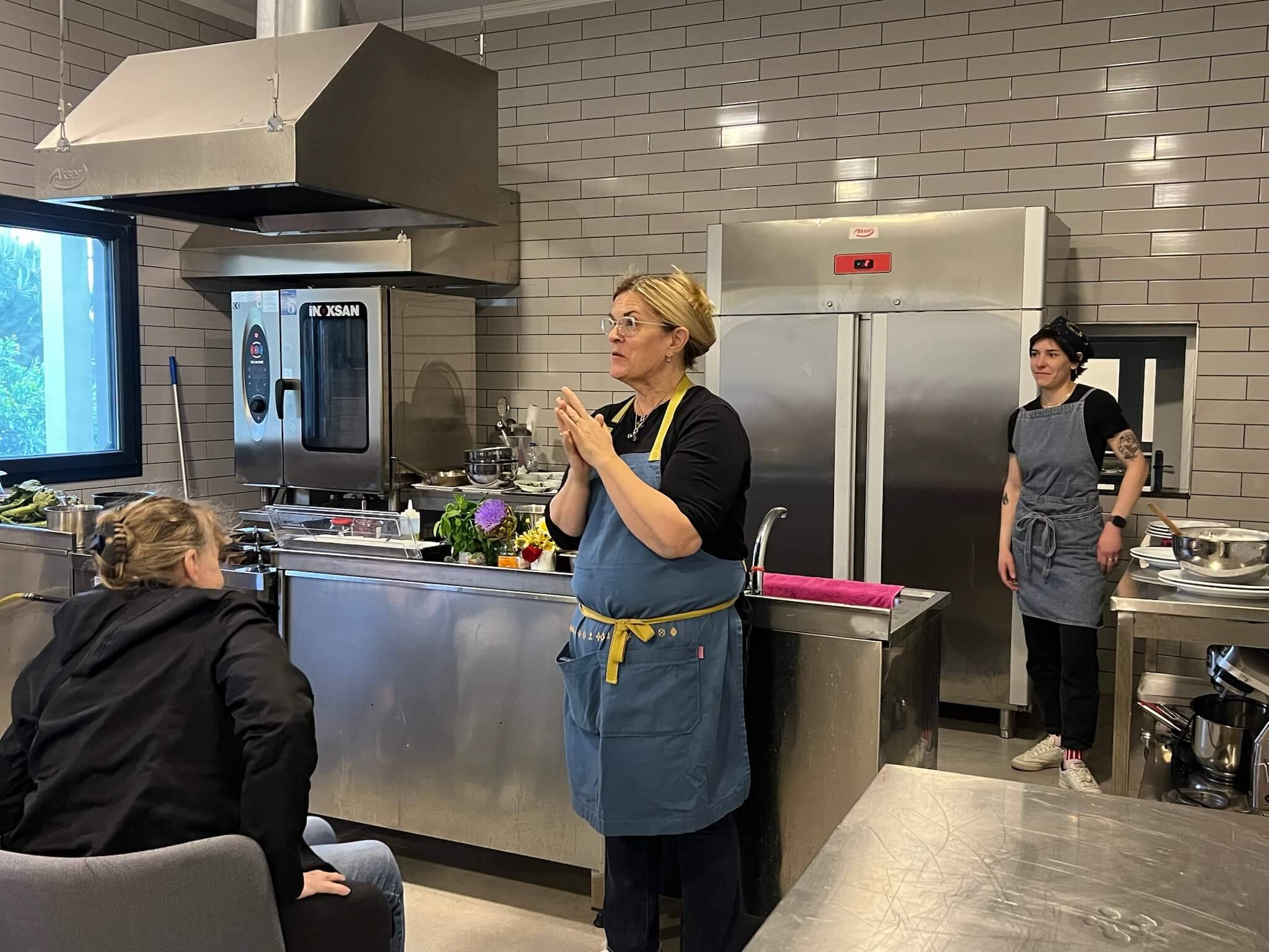 A woman stands in a kitchen, preparing food