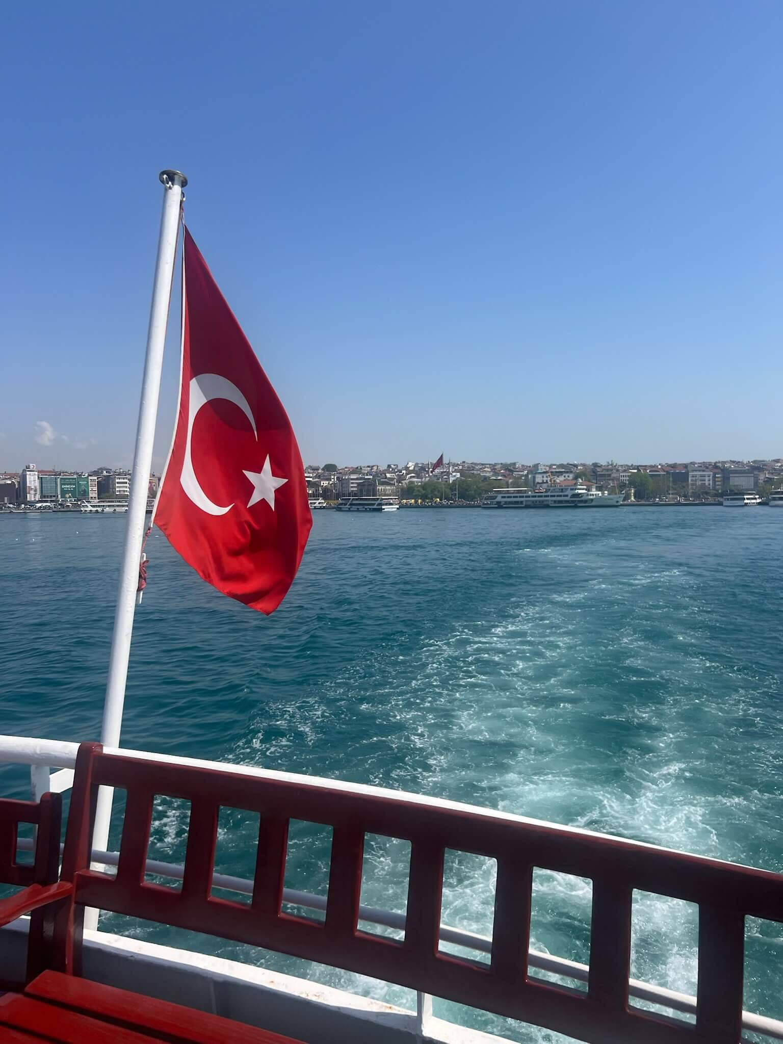 The Turkish flag flutters on the side of a boat