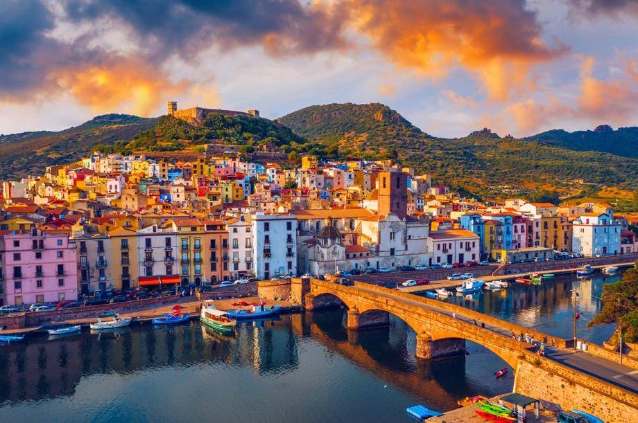 A charming Italian village by the riverside at sunset