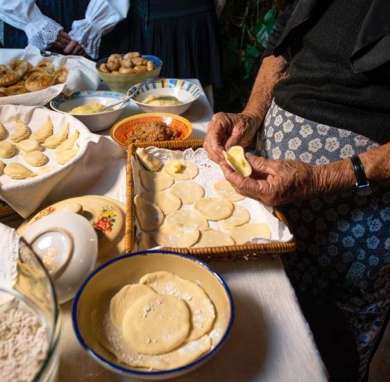 A woman prepares food on a table