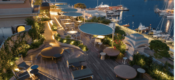 Night view of a harbor featuring a lit restaurant and lounge