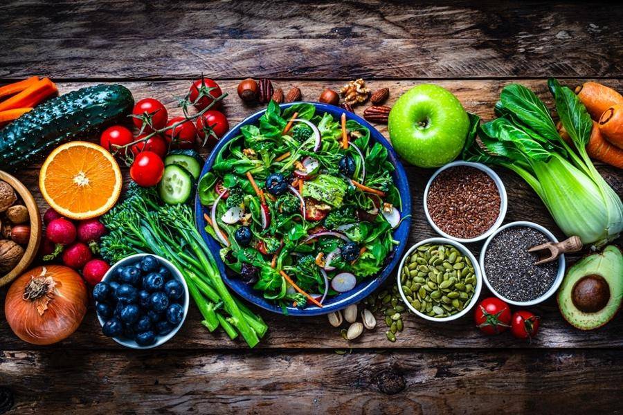 An array of fresh fruits and vegetables arranged in bowls