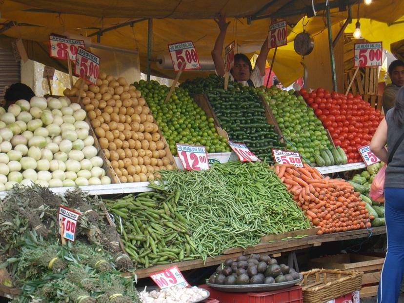 Bustling market stall with neatly stacked vegetables