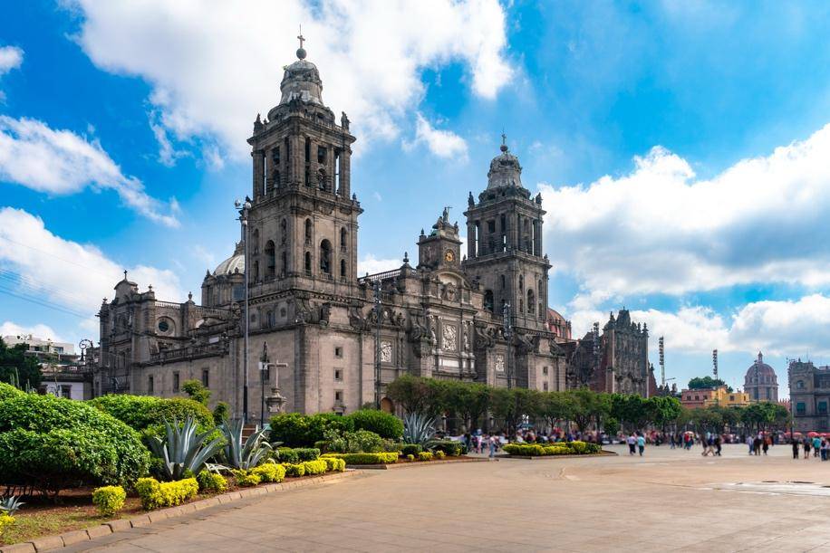 Historic cathedral under a vibrant blue sky with fluffy clouds