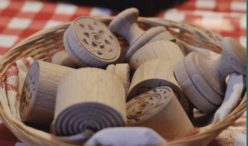 A basket filled with various wooden toys