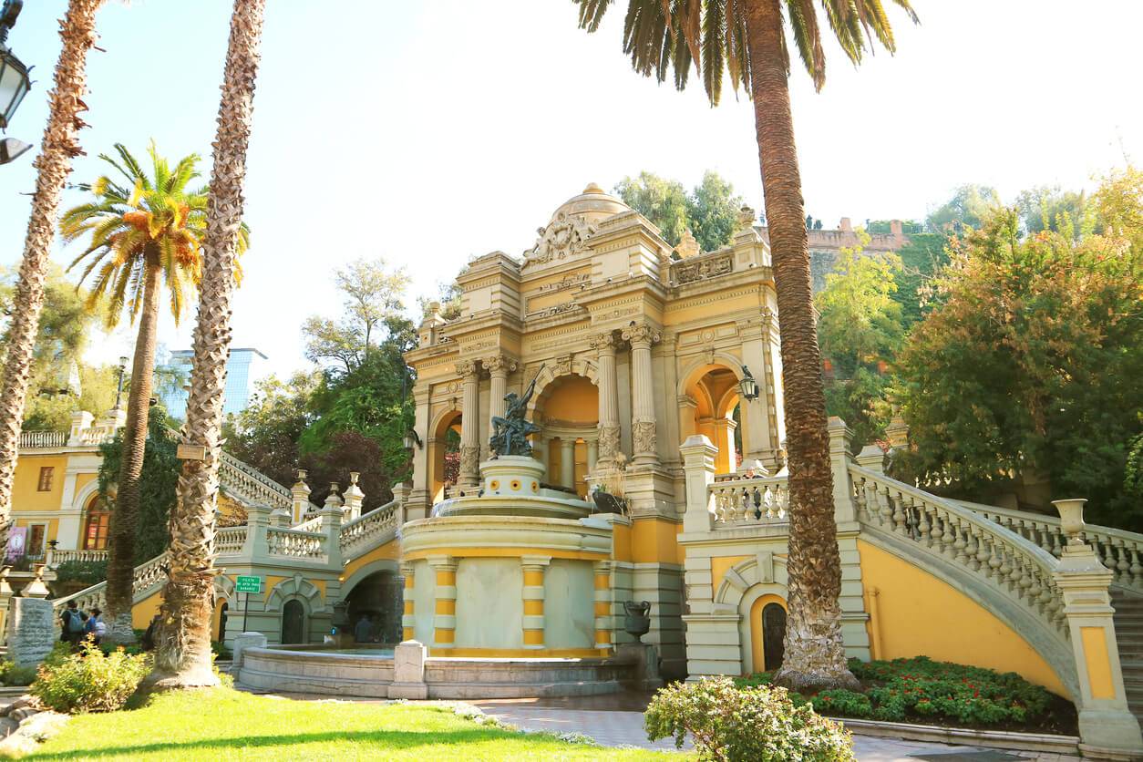 A large building with a fountain in front