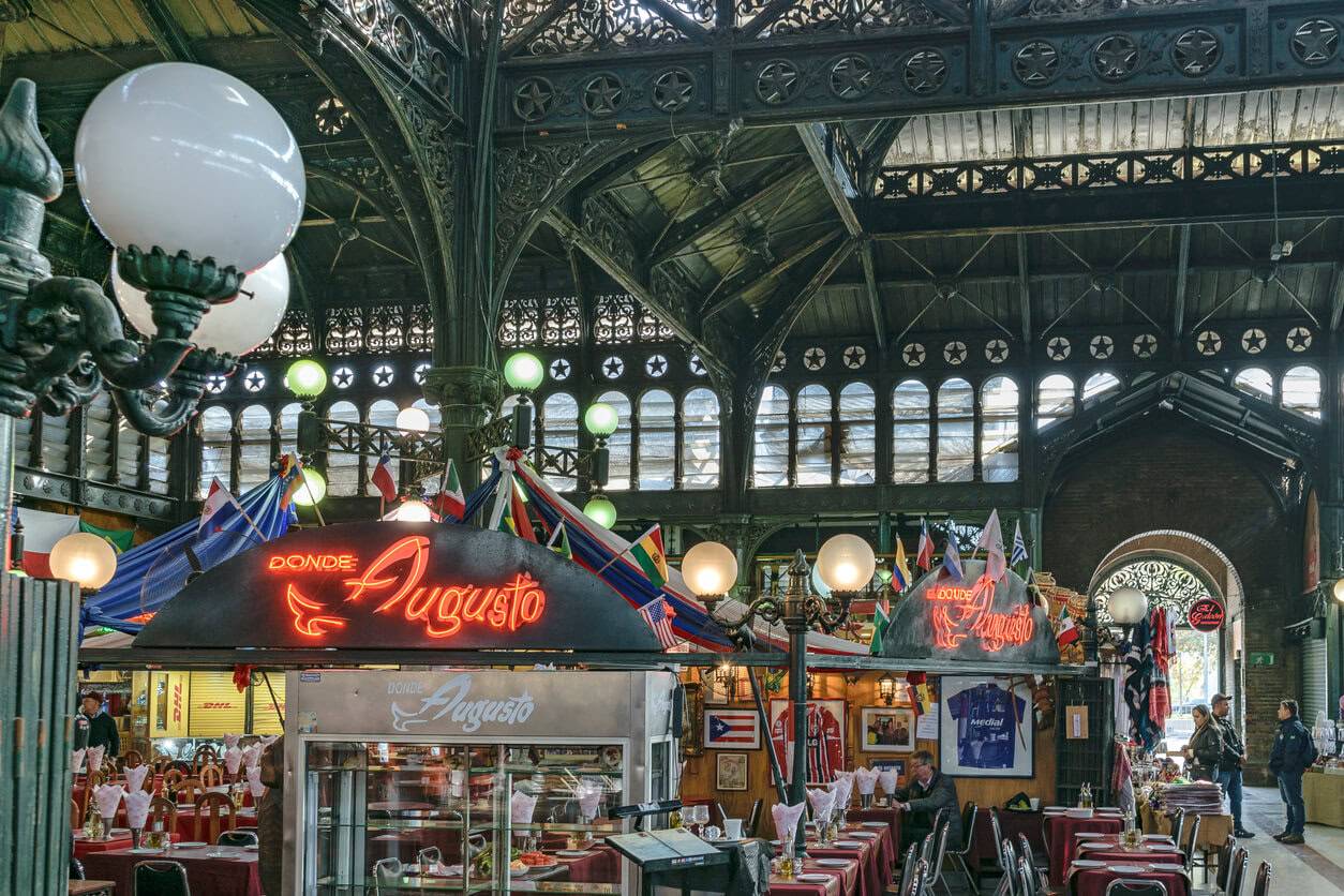 A large indoor market filled with tables and chairs
