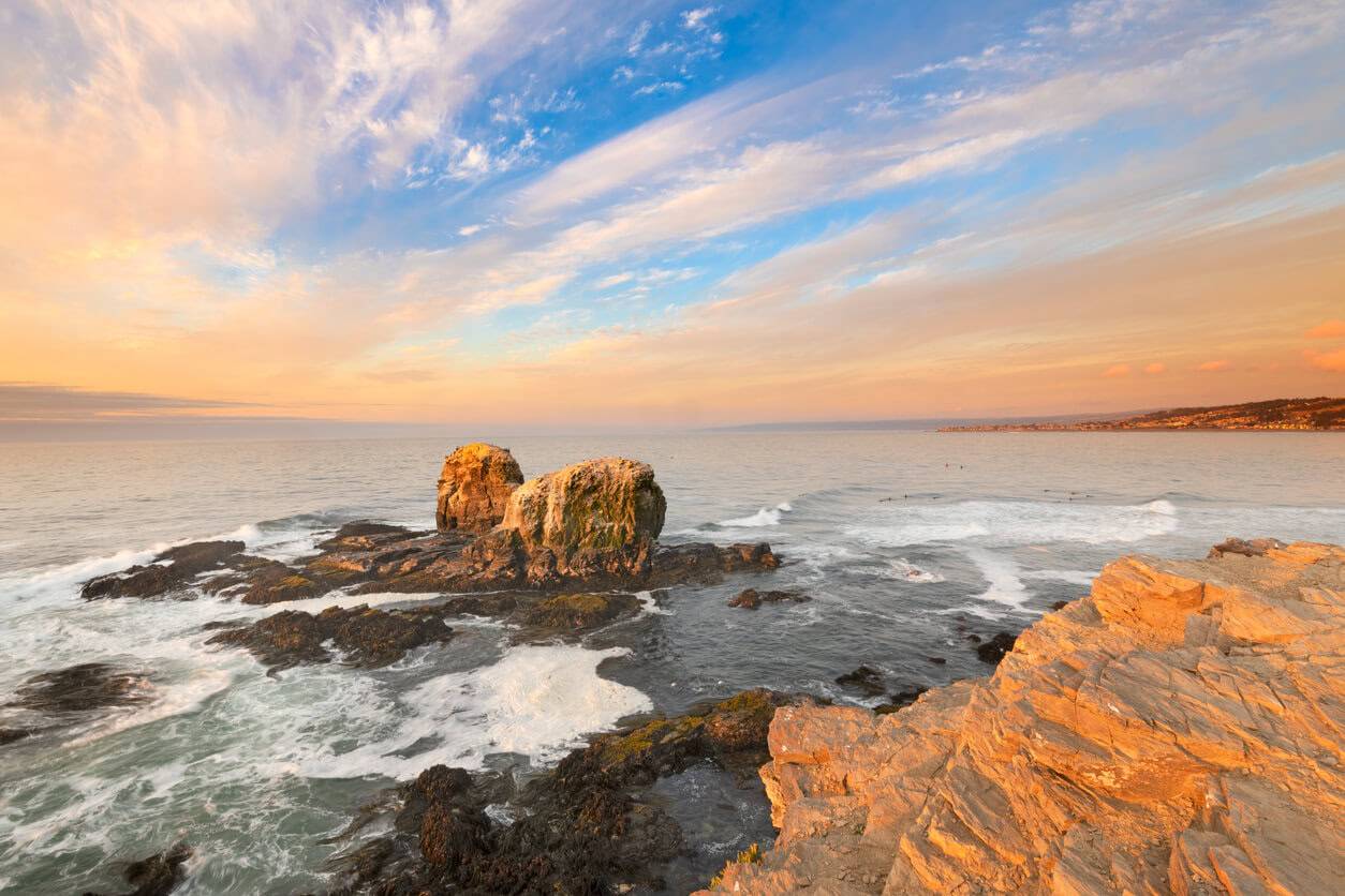 Waves violently crash against a rocky shoreline