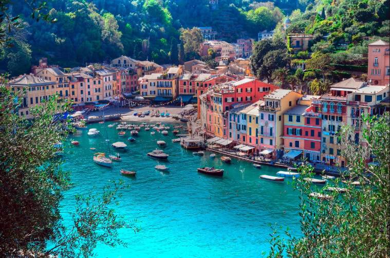 Picturesque coastal village with colorful buildings lining a serene harbor