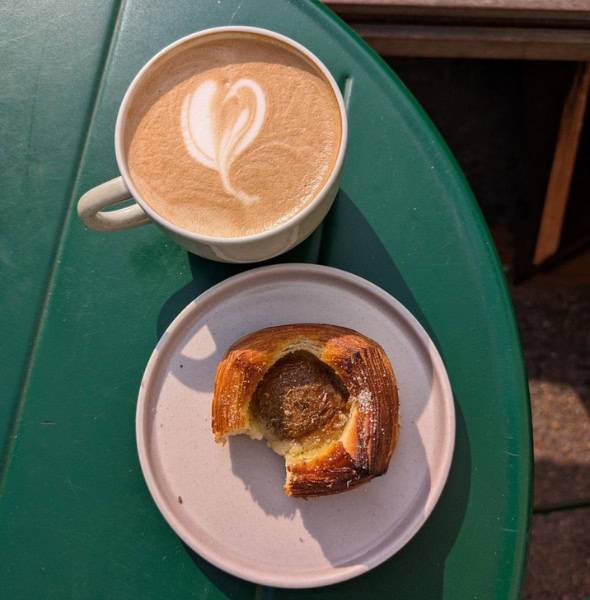 A warm cup of coffee and a delicious pastry