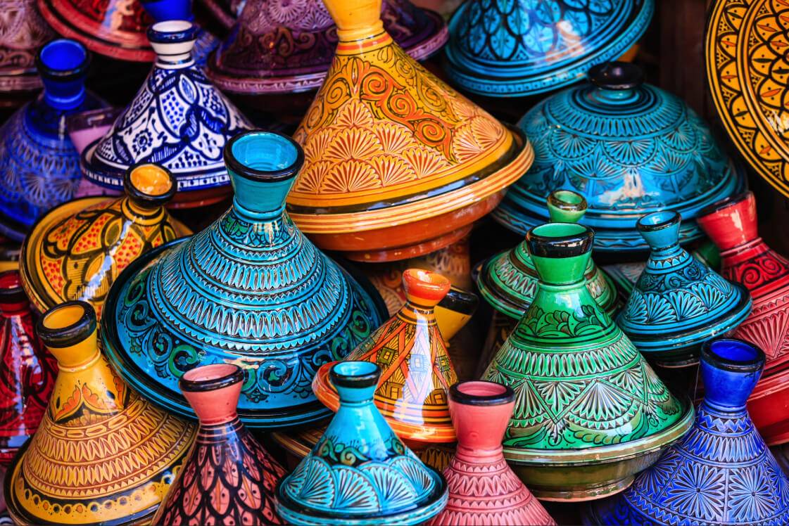 Colorful ceramic tagines in various shapes and designs