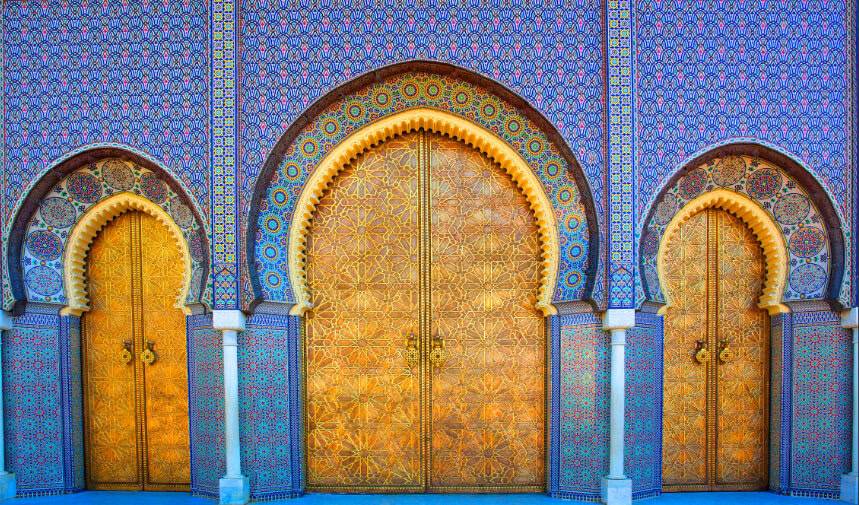 Ornate golden doors with intricate geometric patterns set within arched frames