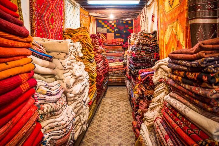 Stacked colorful rugs and carpets in a store