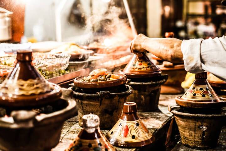 Steaming Moroccan tagines on a kitchen counter
