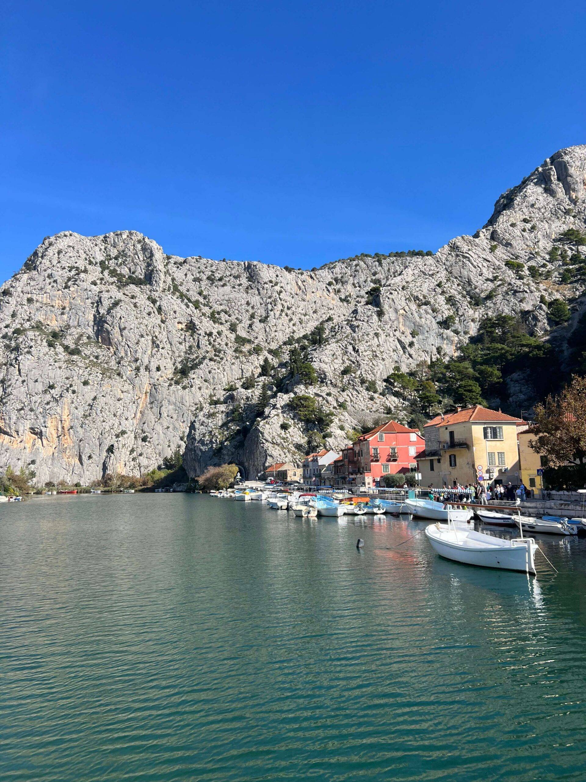 A boat rests at a dock in tranquil waters