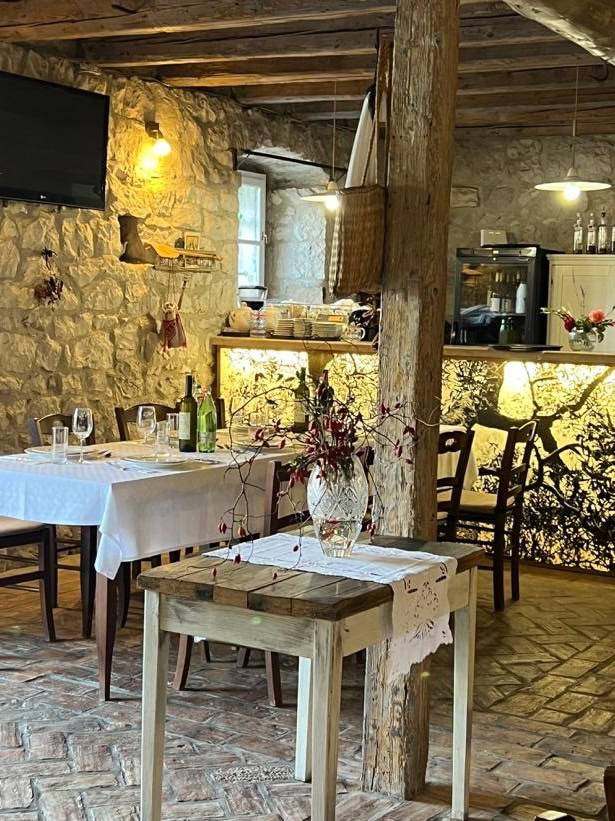 A rustic restaurant featuring stone walls